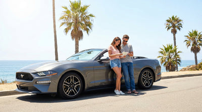 A convertible car hire driving on the Pacific Coast Highway with ocean views in California