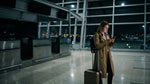 Closed car rental counter with empty desks at night inside a New York airport terminal