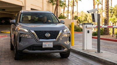 A line of cars at a valet stand including a black car rental at a luxury Las Vegas hotel entrance