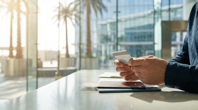 A white SUV car rental parked on a street lined with tall palm trees on a sunny day in Los Angeles