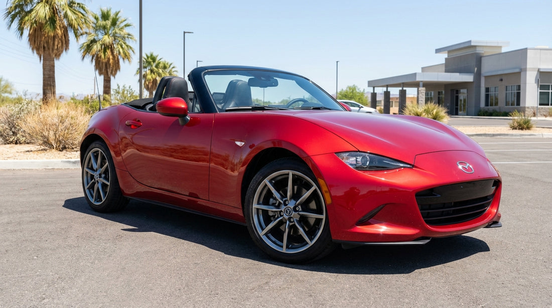 A silver car rental driving on a desert road with the famous Las Vegas skyline in the distance