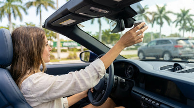 View from the driver's seat of a car hire crossing a bridge with the sunny Miami skyline in the distance