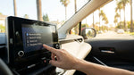 Driver interacting with the digital dashboard screen inside a car rental in Los Angeles