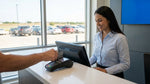 Close up of a person handing a credit card to an agent at a car rental desk in Texas