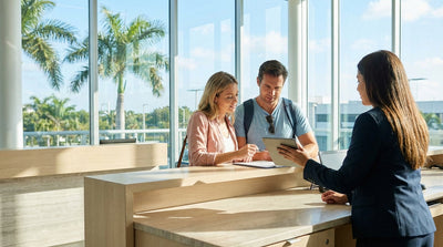 A white convertible car rental driving down a sun-drenched road lined with palm trees in Miami