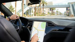 Driver using a sat nav screen inside a car rental on the Las Vegas Strip