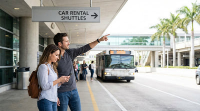 A white car hire shuttle bus picks up passengers outside an LAX terminal building in Los Angeles
