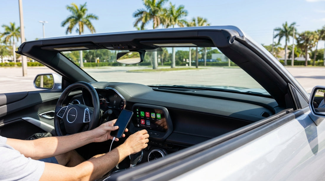 A person's hands plugging a smartphone into the dashboard of a Florida car hire to set up Apple CarPlay