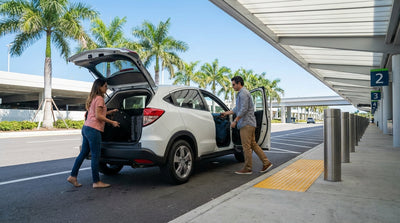 Rows of cars available for car rental at the brightly lit Miami Airport pick-up garage