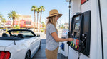 Driver inserting a credit card into a fuel pump to fill up a car rental in Las Vegas
