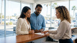 A person signing paperwork for a car hire at an office desk in the United Estates
