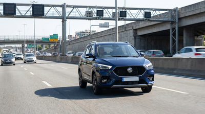 A car rental driving over a bridge in New York with the city skyline in the distance