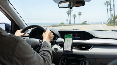 Driver's view from a California car hire with a phone mounted on the dash for navigation on a sunny highway