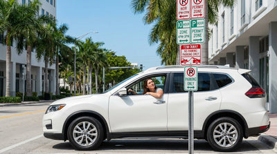 A confusing pole of stacked parking signs on a sunny Miami street with a car rental parked nearby