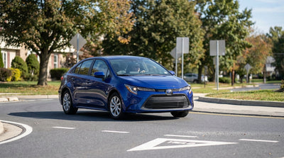A modern car rental navigates a landscaped traffic roundabout in suburban Pennsylvania