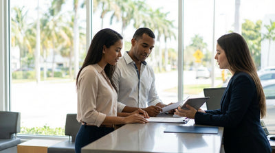 A bright convertible car rental parked on a sunny Miami street with colorful Art Deco hotels and palm trees