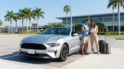 A modern car rental parked beside a white sand beach with palm trees in sunny Florida