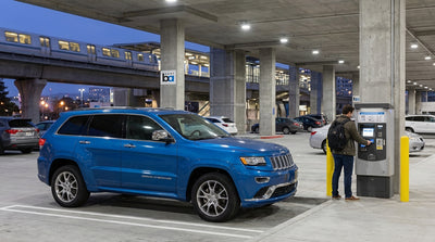 A car hire vehicle parked in an illuminated BART station parking lot in San Francisco at dusk