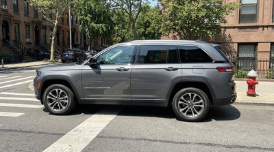 A car hire parked near a red fire hydrant on a busy street in New York City