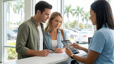 A modern car rental driving on a highway lined with palm trees on a sunny day in Florida
