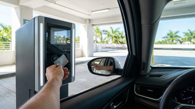 A modern car hire drives on a sunny road lined with palm trees in Los Angeles