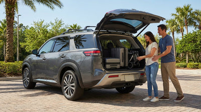 A family with suitcases and a pushchair loading their SUV car rental on a sunny day in Orlando