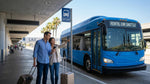 Passengers waiting at a car rental shuttle stop outside an LAX airport terminal in Los Angeles