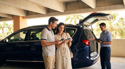 A traveler unlocks their Miami car hire with a smartphone in an airport parking garage