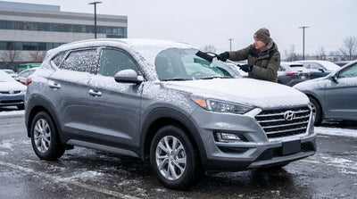 A modern car hire vehicle on a New York street, its roof and windows completely covered by a thick layer of fresh snow