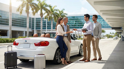 A modern white SUV car rental parked in front of the Miami International Airport terminal under a bright blue sky