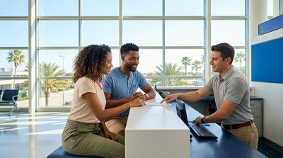 A person smiles while holding the keys to their car rental on a sunny street in Orlando