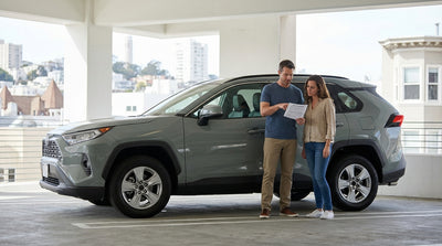 A red convertible car rental driving across the Golden Gate Bridge in San Francisco on a sunny day
