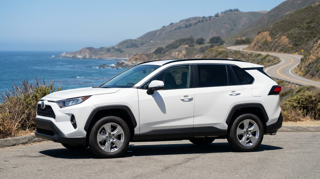 A convertible car hire driving on a scenic highway overlooking the Pacific Ocean in California