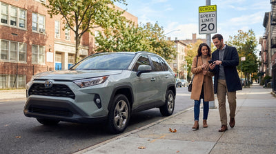 A car hire drives on a New York City street towards a school zone speed camera
