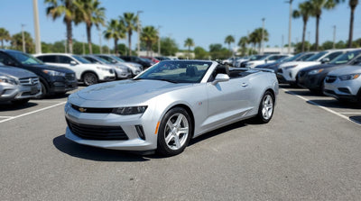 A silver SUV car hire on a scenic desert road trip through the United States