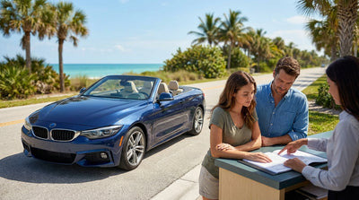A convertible from a car hire driving a sunny coastal highway in Florida with palm trees and the ocean in the background