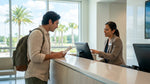 A traveler looks concerned while reviewing a car hire agreement at a rental counter in Orlando