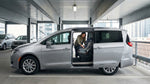 Parent buckling a child into a safety seat inside a car rental parked on a New York street