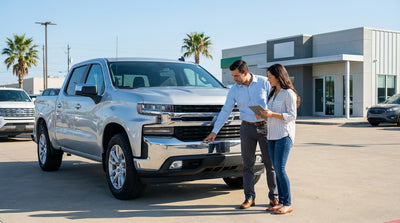 A modern car rental driving down a scenic highway through the vast, open landscape of West Texas