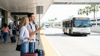 A car rental shuttle bus waits for travelers outside the Terminal 7 arrivals curb at LAX in Los Angeles