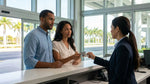 Customer reviewing booking documents with an agent at a car rental desk in Miami