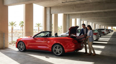 White SUV parked at a Las Vegas airport car rental lot under a clear sky