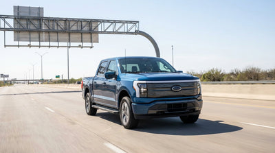 A car rental approaches an electronic toll gantry on a sunny highway in Texas