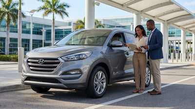 A person at a counter hands over a credit card to complete their Orlando car hire pickup