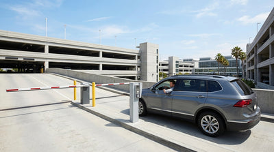 A car waits at the closed gate of a car rental return facility at the airport in Los Angeles