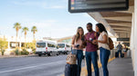 A shuttle bus for the car rental center picking up passengers outside the Las Vegas airport terminal