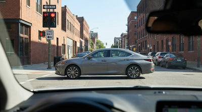 A car hire vehicle stopped at a red traffic light on a one-way street with historic buildings in Philadelphia, Pennsylvania