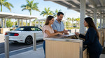A customer uses a credit card to complete their car hire paperwork at a rental desk in Florida