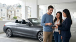 Hand passing a credit card to an agent at a car hire desk in San Francisco