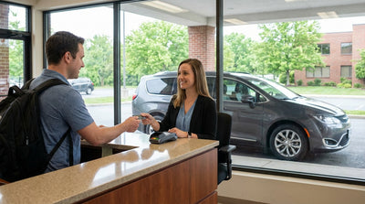A modern car hire vehicle driving on a scenic highway through the mountains of Pennsylvania in the fall
